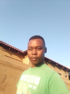 a picture of Olwethu Matebese, wearing a greenshirt on a sunny day.